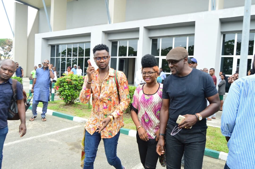 Louiza Williams walking with music industry professionals